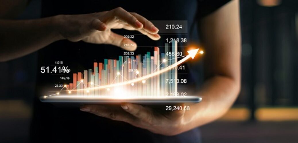Businessman holding tablet and showing a growing virtual hologram of statistics, graph and chart with arrow up on dark background. Stock market. Business growth, planing and strategy concept.